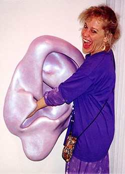 woman feels inside ear