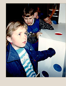 kids with hands in mystery box