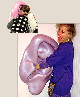 woman with hand in ear