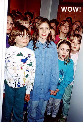 eager children peer into the book